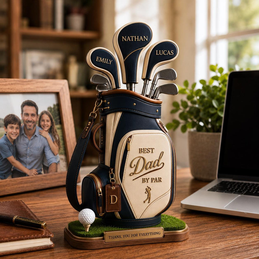 May include: A navy blue and cream-colored golf bag with golf clubs, personalized with names. The bag has the words "Best Dad by Par" and a golf ball on a tee. A wooden base reads "Thank you for everything."