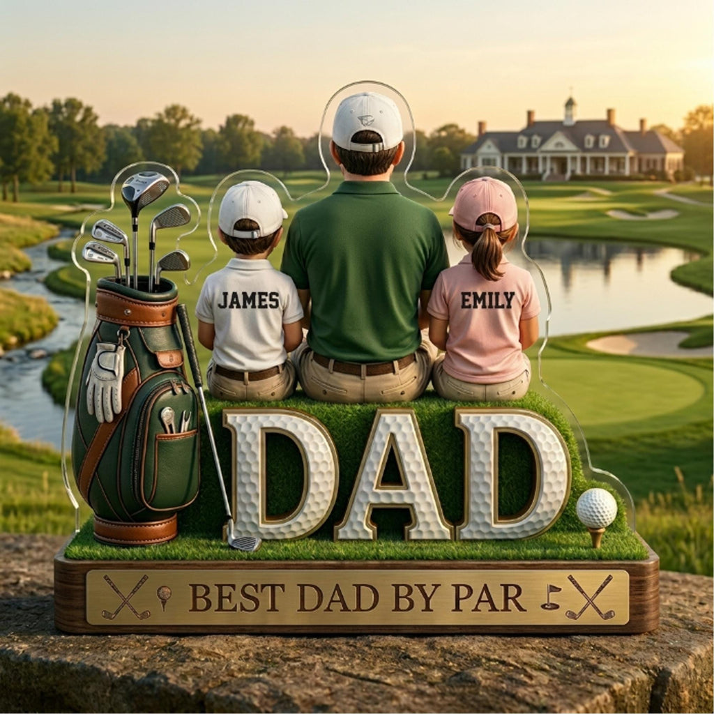 May include: A golf-themed acrylic display featuring a father and two children, with the word "DAD" in large letters. The display includes a golf bag, golf clubs, and the text "BEST DAD BY PAR". The background shows a golf course.