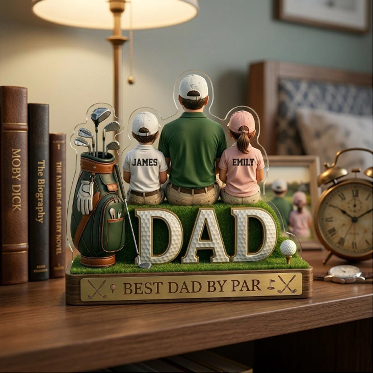 May include: A golf-themed acrylic display featuring a father and two children, with the word "DAD" in large letters. The display includes a golf bag, golf clubs, and the text "BEST DAD BY PAR". The children's shirts are labeled "JAMES" and "EMILY".