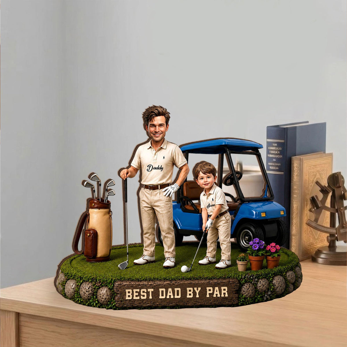 May include: A decorative figurine featuring a man and a child in golf attire, standing on a green, grassy base. A blue golf cart is behind them. The base has the text "BEST DAD BY PAR".