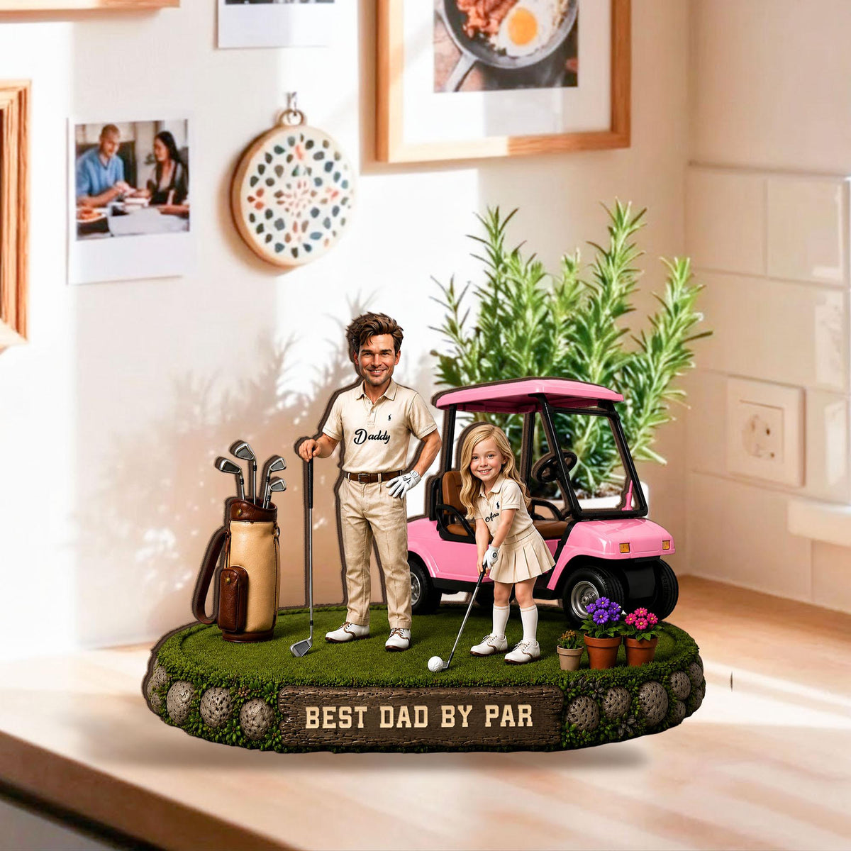 May include: A decorative figurine featuring a man and a girl on a golf course with a pink golf cart. The base reads "BEST DAD BY PAR". The man is holding a golf club and the girl is about to hit a golf ball. A golf bag and clubs are also present.