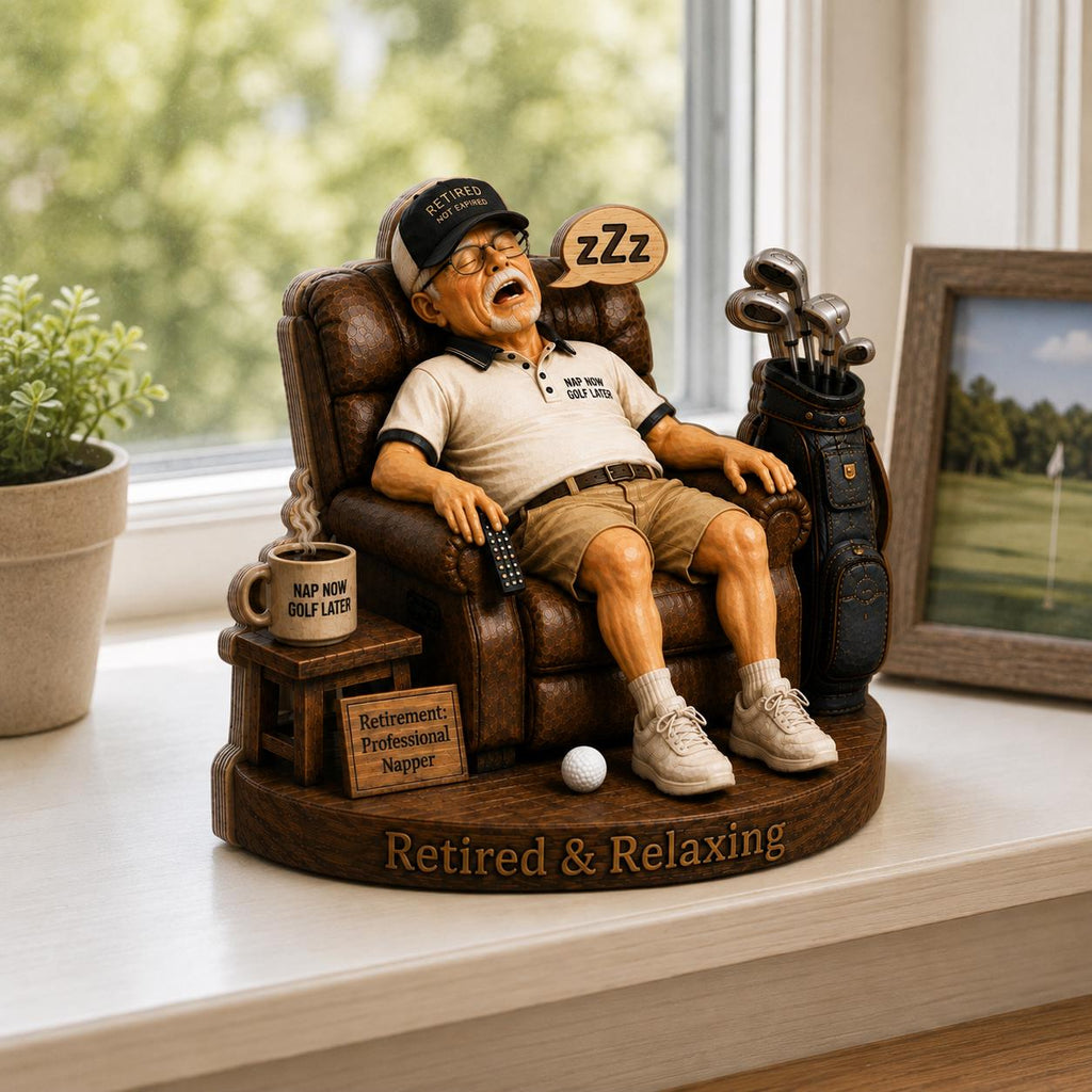 May include: A figurine of a person sleeping in a brown recliner, wearing a cap that says RETIRED NOT EXPIRED, a shirt saying NAP NOW GOLF LATER, and shorts. A golf bag, a mug labeled NAP NOW GOLF LATER, a sign saying Retirement: Professional Napper, and text Retired & Relaxing.