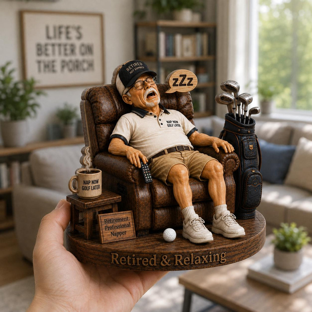 May include: A figurine of a retired person sleeping in a brown leather armchair, wearing a cap that says RETIRED NOT EXPIRED, a shirt reading NAP NOW GOLF LATER, and holding a remote. A golf bag, mug, and sign reading Retirement: Professional Napper are included.