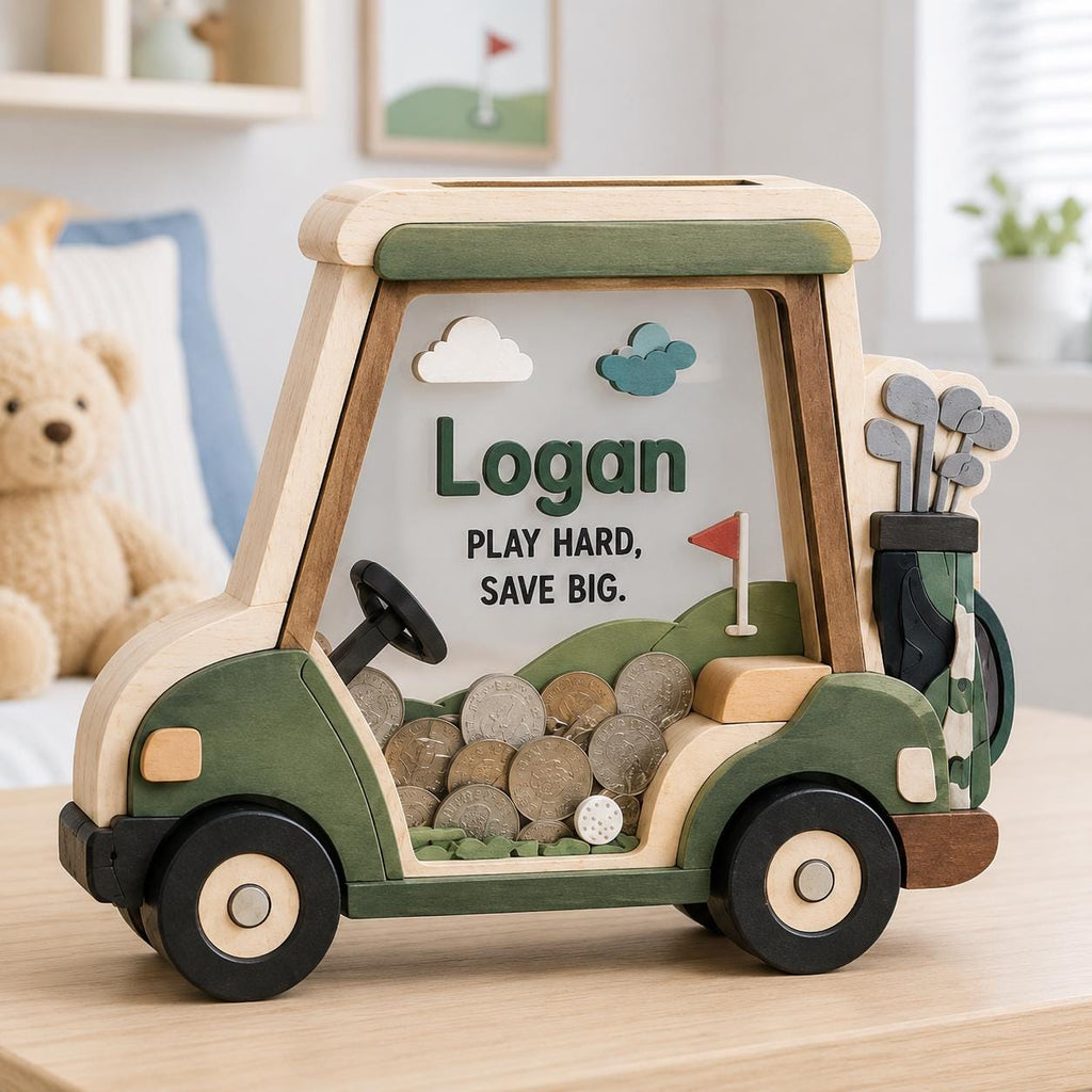 May include: A wooden golf cart-shaped piggy bank with a clear front panel. The text "Logan" and "PLAY HARD, SAVE BIG." is printed on the front. The design includes green and natural wood tones, a steering wheel, and a golf bag with clubs.