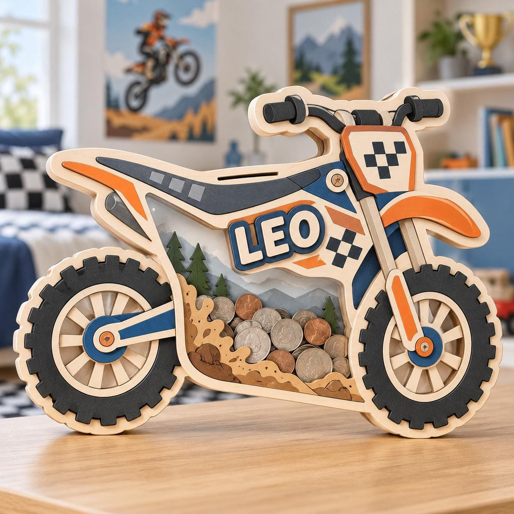 May include: A wooden motorcycle-shaped piggy bank featuring the name LEO in bold letters. The design includes orange, blue, and black accents with a clear panel displaying a collection of coins inside. The frame depicts a mountain and forest scene.