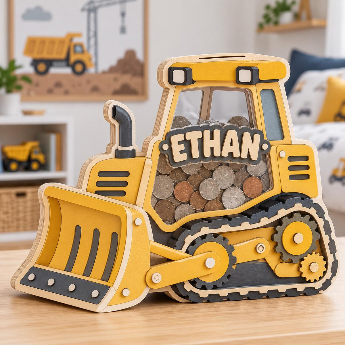 May include: A yellow and black wooden bulldozer-shaped piggy bank with a clear acrylic panel showing a collection of coins inside. The side of the construction vehicle features the name ETHAN in raised wooden letters, with a black exhaust pipe.