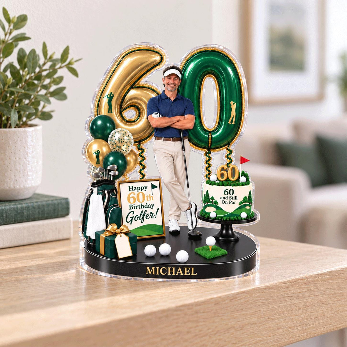 May include: A decorative 60th birthday display featuring a cutout of a golfer, large gold and green number balloons, a golf bag, a gift box, and a cake topper with the text 60 and Still On Par. The base is black with the name MICHAEL printed on it.