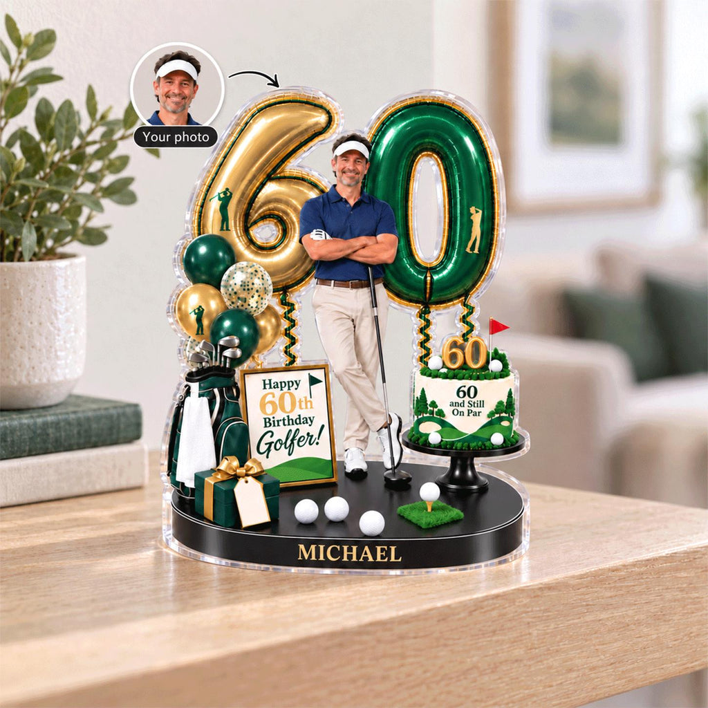 May include: A personalized 60th birthday acrylic display featuring a golfer figure, gold and green balloon-shaped numbers, a golf bag, a gift box, and a cake topper with the text 60 and Still On Par. The base is labeled with the name MICHAEL.