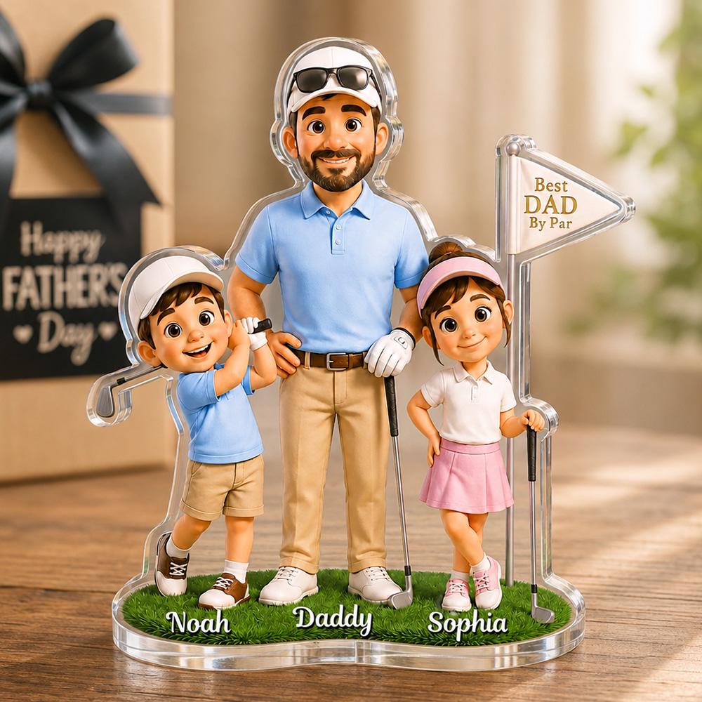 May include: A clear acrylic golf-themed figurine featuring a father and two children. The father wears a blue polo shirt and khaki pants. The children are dressed in golf attire. The base has the names "Noah", "Daddy", and "Sophia". A sign reads "Best DAD By Par".