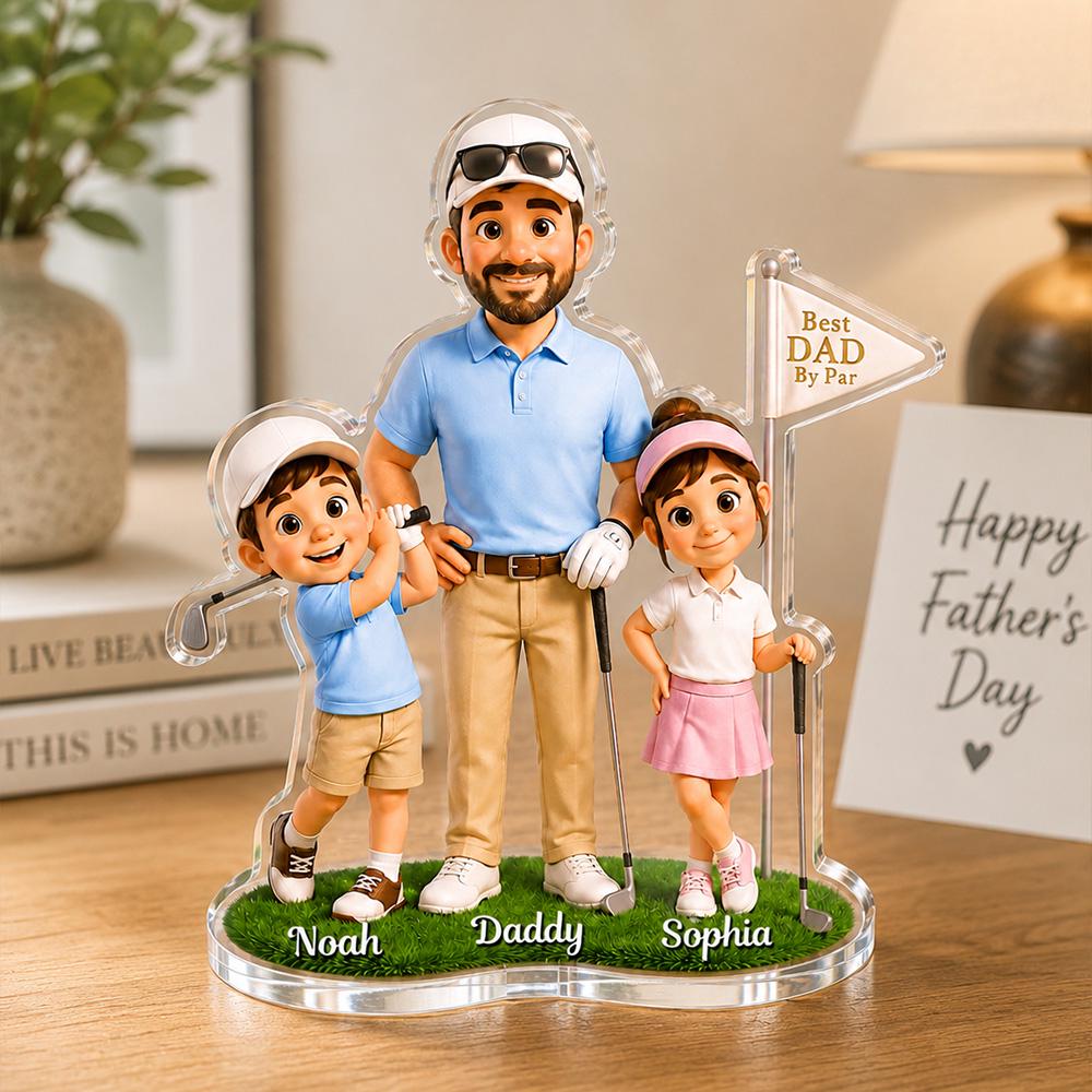 May include: A personalized Father's Day golf-themed acrylic figurine. It features a father with his two children, each holding golf clubs. The base is green, with the names "Noah", "Daddy", and "Sophia". A sign reads "Best Dad By Par".