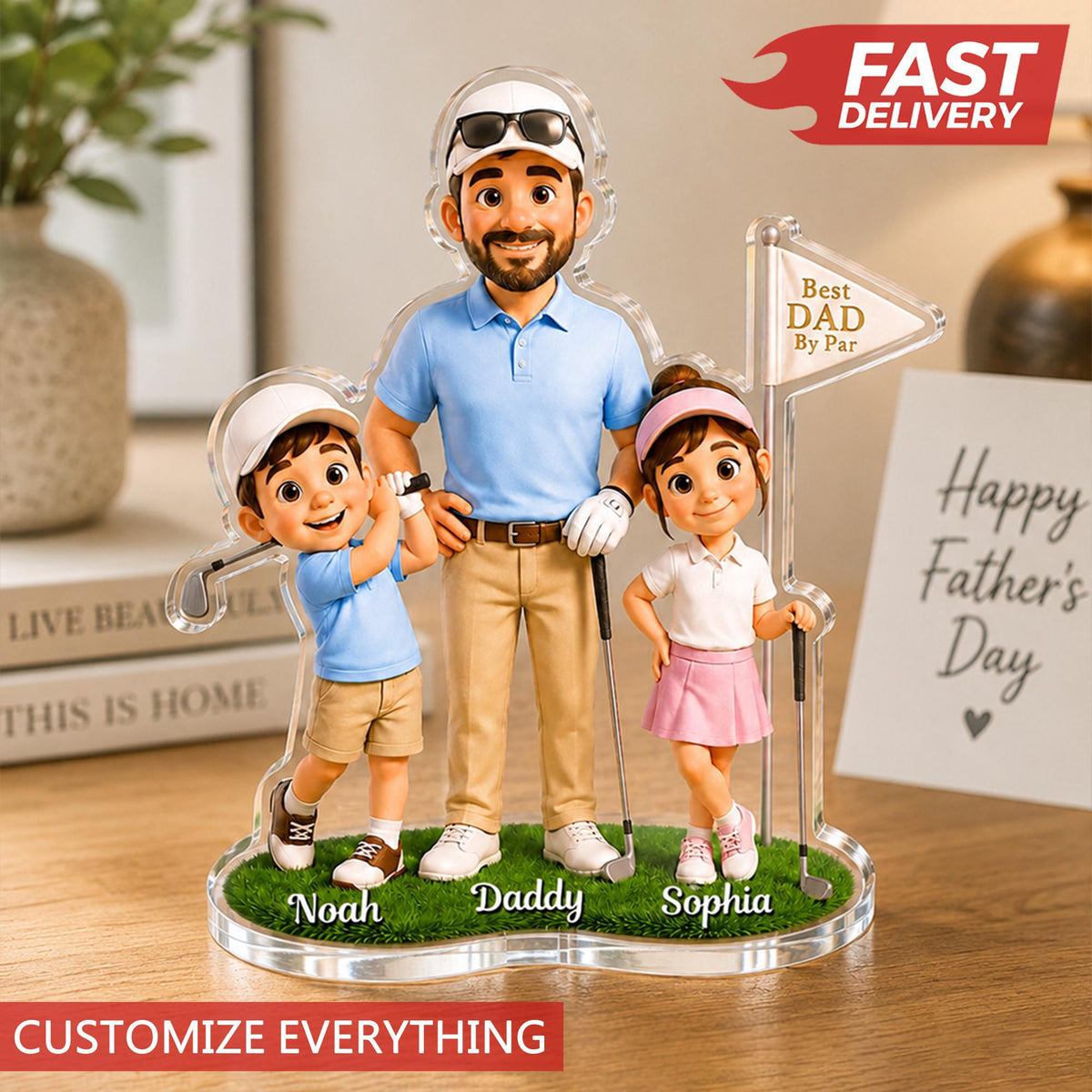 May include: A personalized acrylic Father's Day gift featuring a father and two children dressed in golf attire. The figures stand on a green base with the names "Noah", "Daddy", and "Sophia". A sign reads "Best Dad By Par". The text "Customize Everything" is at the bottom.