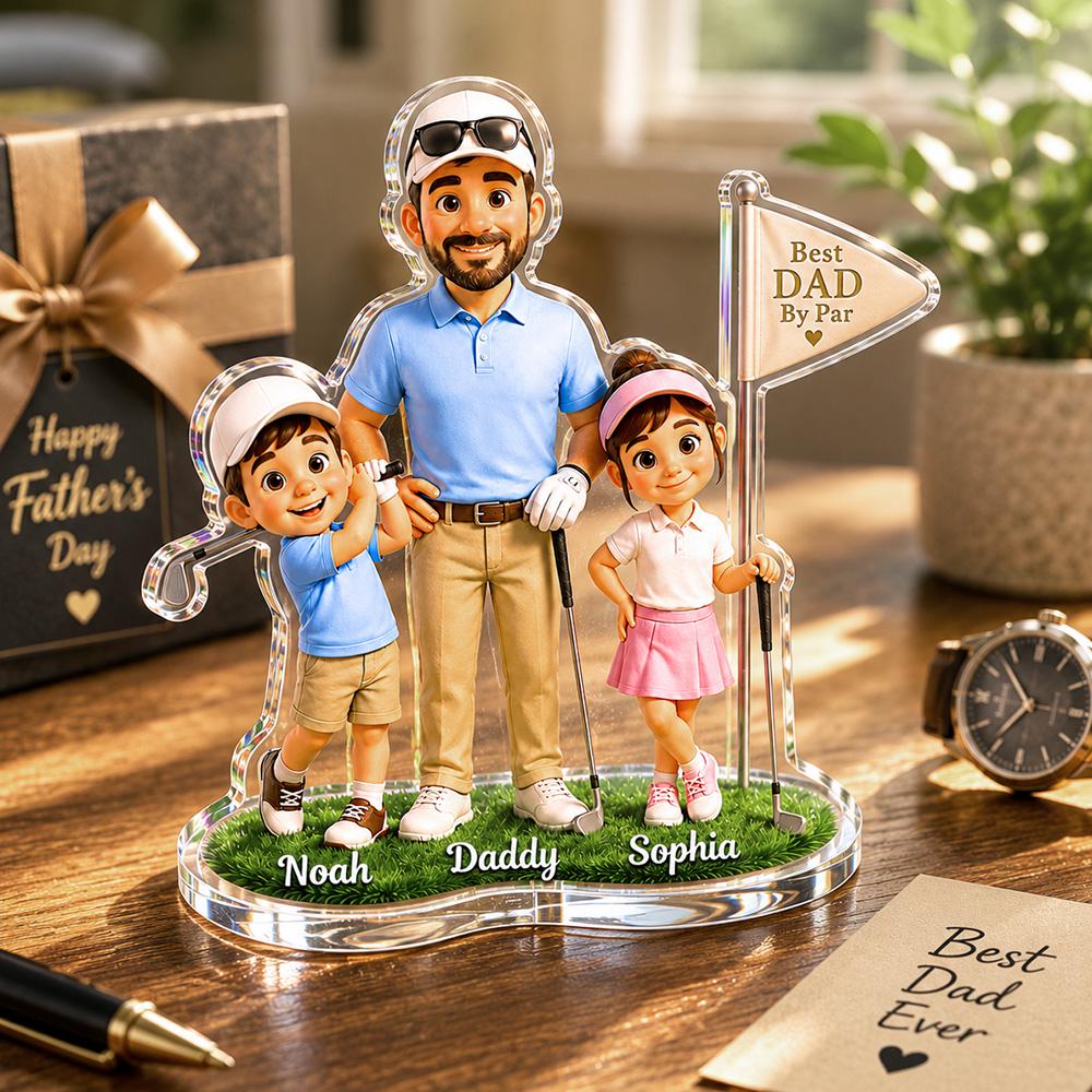 May include: A clear acrylic Father's Day gift featuring a father and two children dressed in golf attire. The base has the names "Noah", "Daddy", and "Sophia". A golf flag reads "Best Dad By Par". A gift box and watch are in the background.