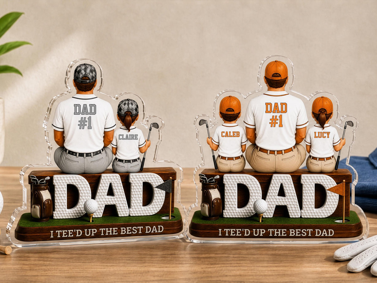 May include: Two personalized acrylic golf-themed desk ornaments featuring figures of a parent and children sitting on a base with the word DAD, a golf bag, a golf ball, and a flag. The base text reads I TEE'D UP THE BEST DAD.