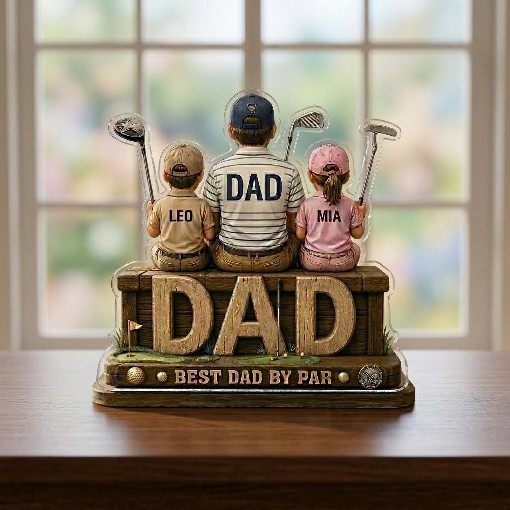 May include: A decorative golf-themed figurine featuring a father and two children, each holding a golf club. The word "DAD" is prominently displayed. The text "BEST DAD BY PAR" is also visible.