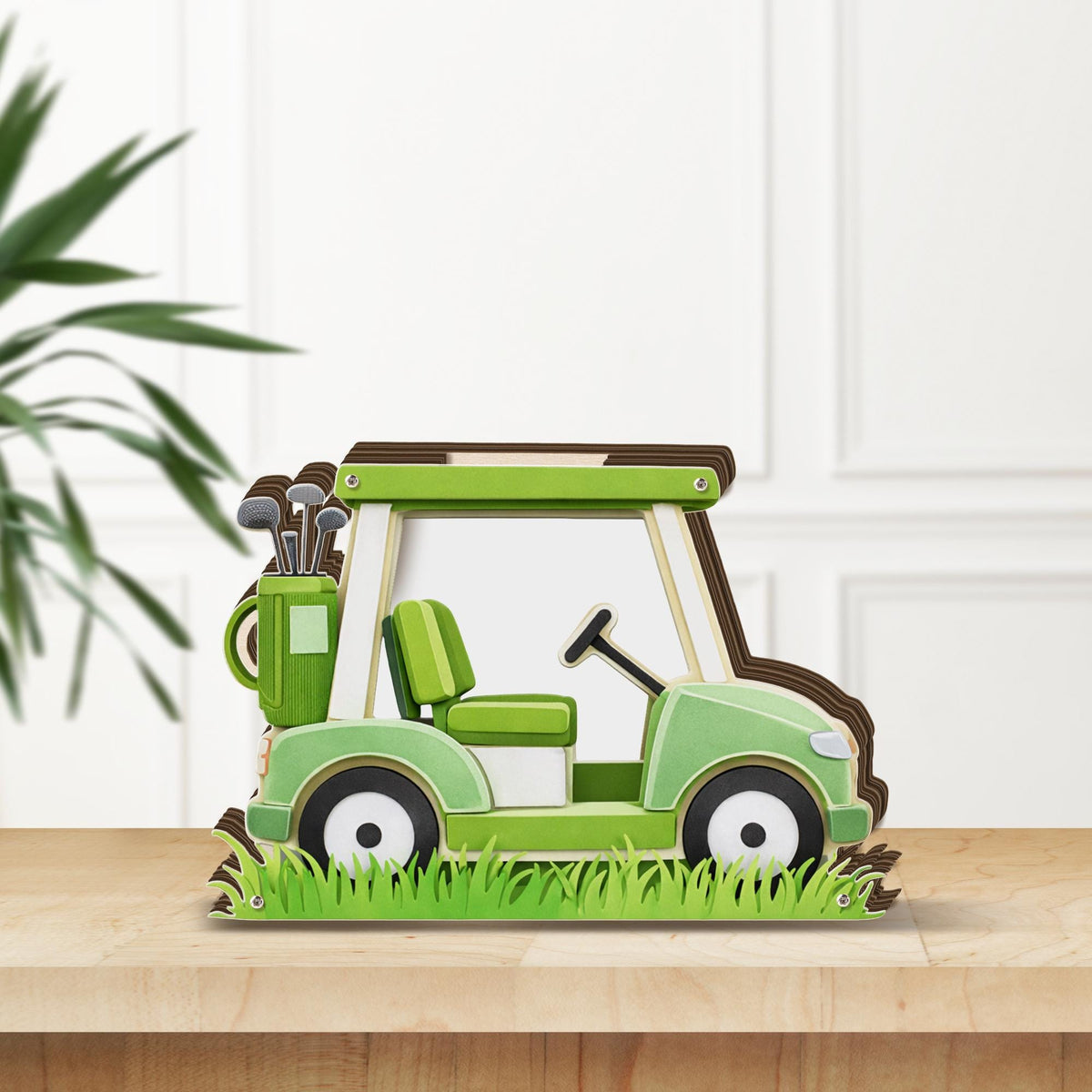 May include: A decorative wooden golf cart in shades of green, brown, and white. The cart features a steering wheel, seat, and a golf bag with clubs. The base includes cut-out grass, and the cart is displayed on a wooden surface.