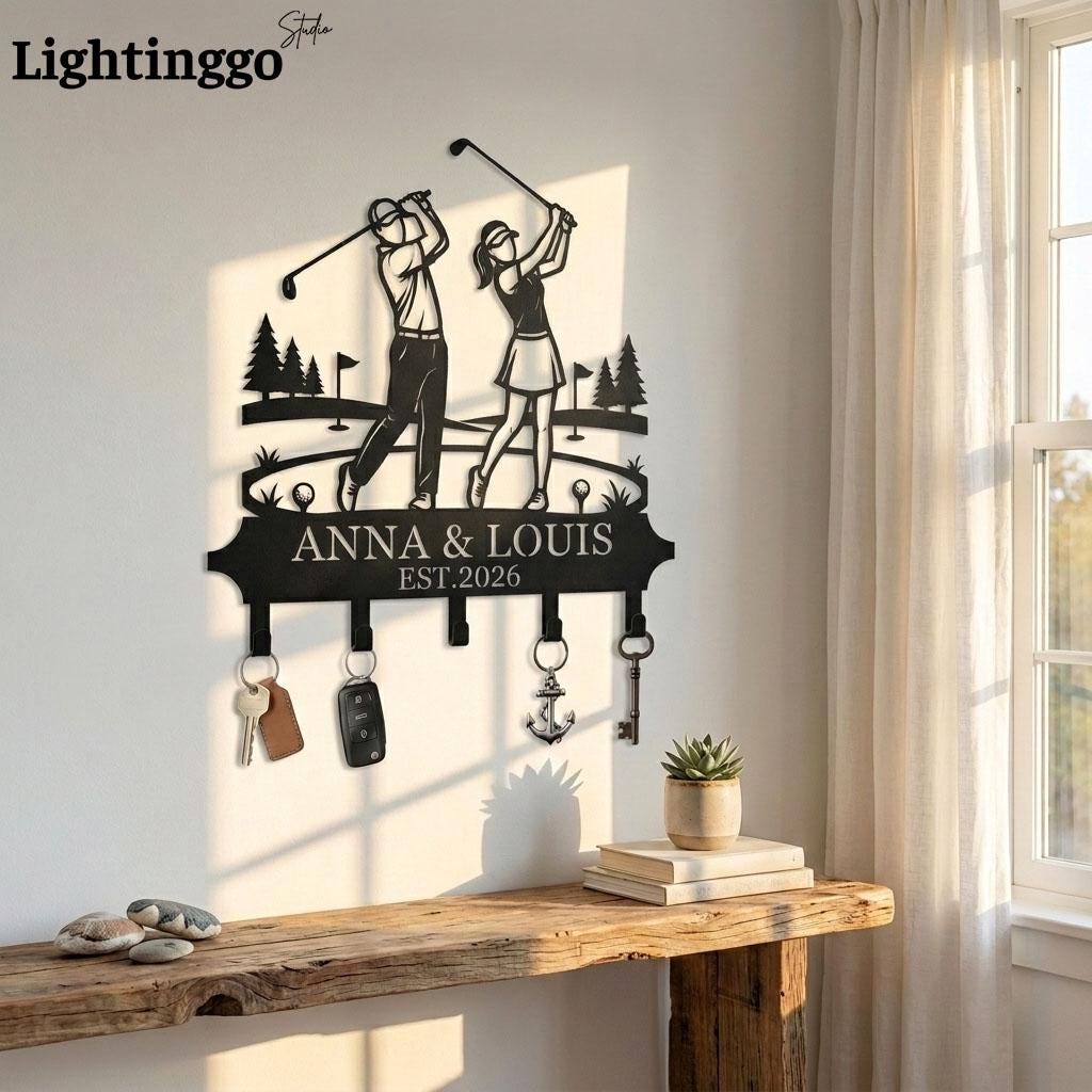 May include: Black metal key holder featuring a golf-themed design with two golfers swinging clubs. The key holder includes hooks for keys and the text "ANNA & LOUIS EST.2026".