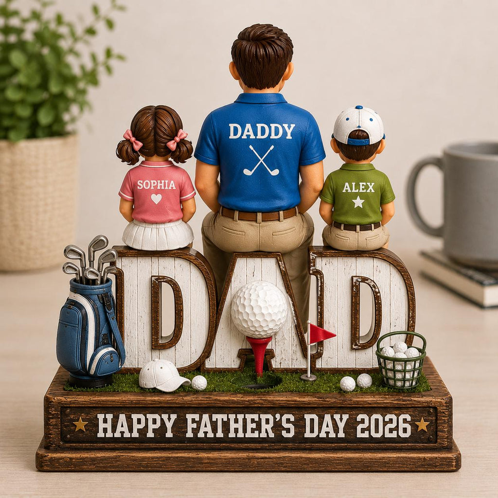 May include: A Father's Day figurine featuring a father figure with two children, Sophia and Alex, seated on the letters of "DAD". The figurine includes a golf theme with a golf bag, golf balls, and a golf hole. The base reads "HAPPY FATHER'S DAY 2026".