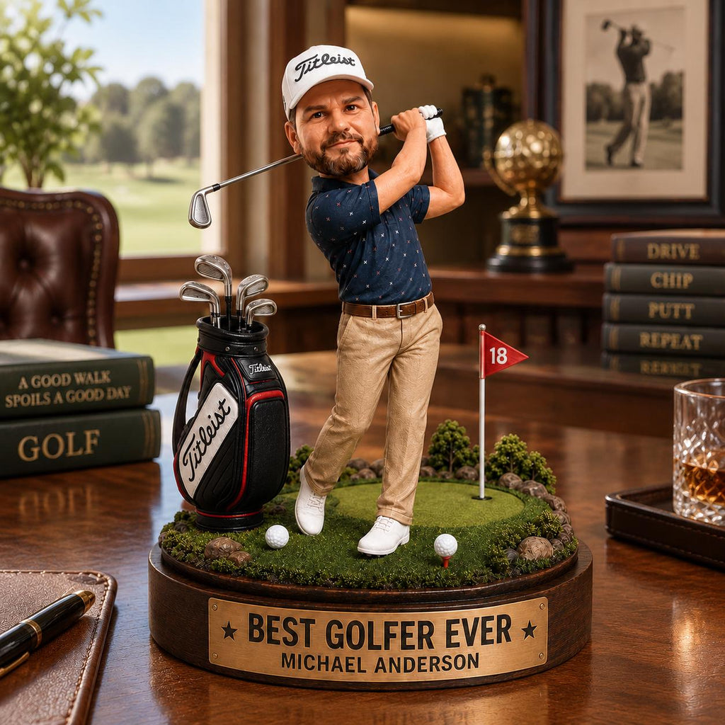 May include: A custom bobblehead figurine of a golfer in a navy patterned polo and tan trousers, swinging a club on a green base. The base features a red flag marked 18, a golf bag, and a brass plaque reading BEST GOLFER EVER MICHAEL ANDERSON.