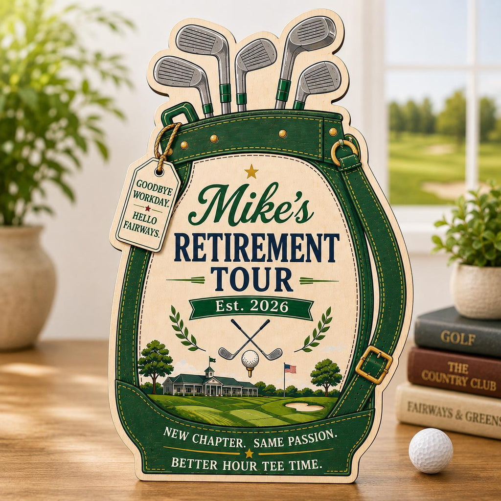 May include: A wooden golf bag-shaped sign featuring green and cream colors. Text reads: Mike's RETIREMENT TOUR, EST. 2026, NEW CHAPTER. SAME PASSION. BETTER HOUR TEE TIME. A hanging tag says: GOODBYE WORKDAY. HELLO FAIRWAYS. Includes golf club and course graphics.
