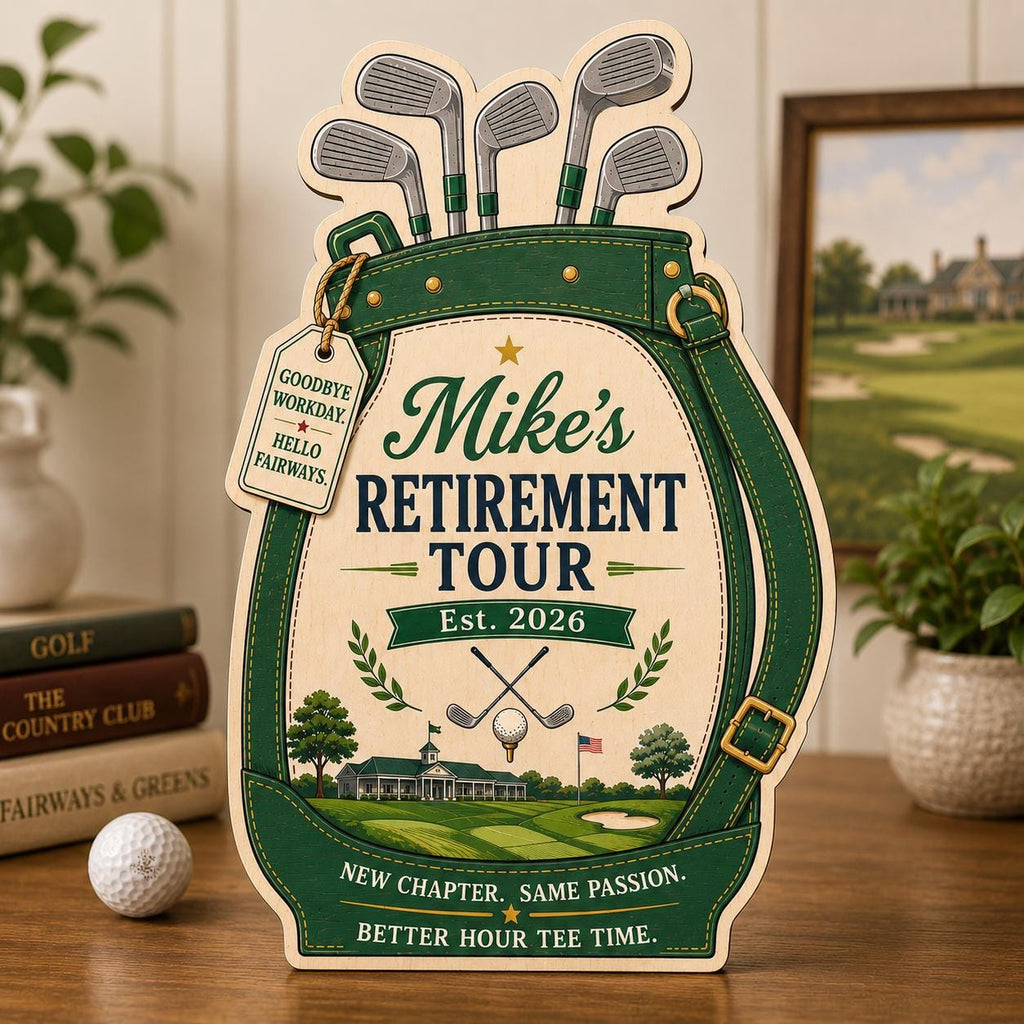 May include: A wooden sign shaped like a golf bag with green trim, featuring the text 'Mike's RETIREMENT TOUR Est. 2026', 'GOODBYE WORKDAY. HELLO FAIRWAYS.', 'NEW CHAPTER. SAME PASSION. BETTER HOUR TEE TIME.', golf clubs, a golf ball, and a clubhouse illustration.