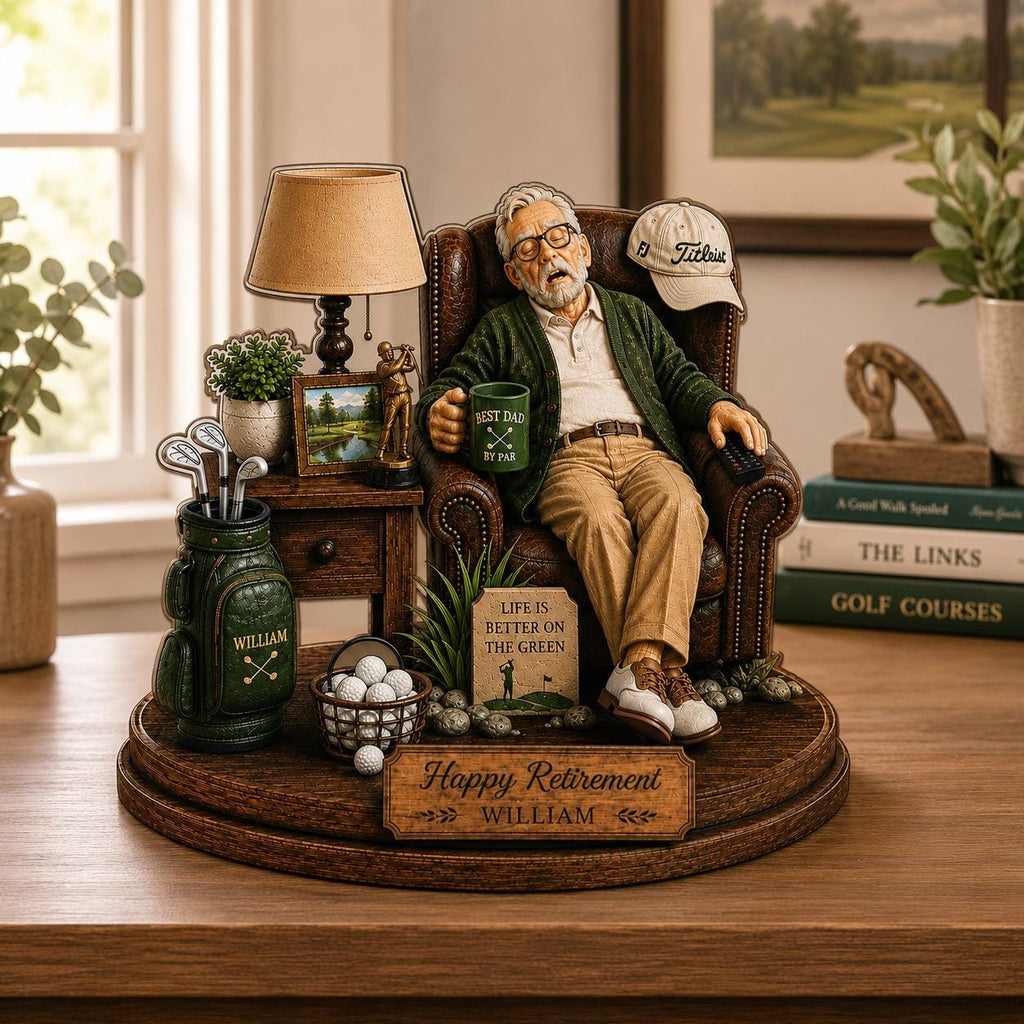 May include: A decorative figurine of an older person resting in a brown leather armchair, holding a green mug labeled 'BEST DAD BY PAR'. The base features a sign reading 'Happy Retirement WILLIAM' and a golf bag with the name 'WILLIAM'.