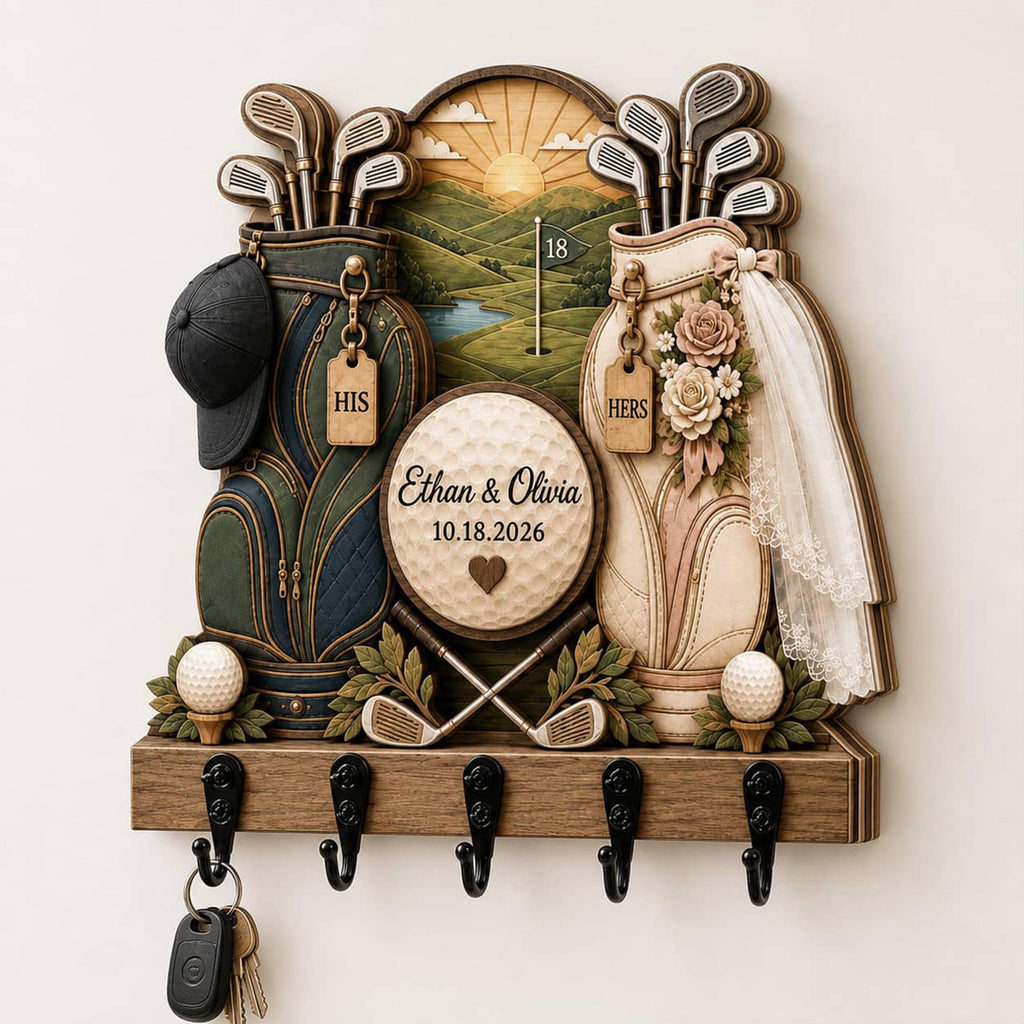 May include: A wooden wall-mounted key holder featuring two golf bags, one dark green and one cream, with golf clubs, a central golf ball plaque reading Ethan & Olivia 10.18.2026, a black cap, a white veil, floral accents, and five black metal hooks.