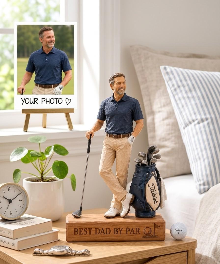 May include: A custom figurine of a golfer wearing a navy blue polo shirt and khaki pants, standing on a wooden base engraved with the text BEST DAD BY PAR. The figure holds a golf club and stands next to a blue golf bag filled with clubs.