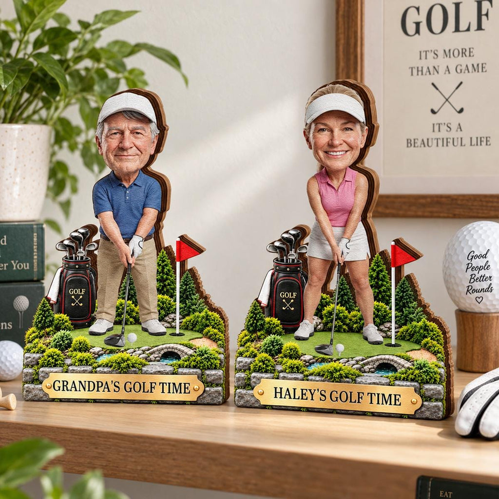 May include: Two custom bobblehead figures on golf course bases. One figure wears a blue polo and khaki pants with a plaque reading GRANDPA'S GOLF TIME. The other wears a pink top and white skirt with a plaque reading HALEY'S GOLF TIME. Both hold clubs.