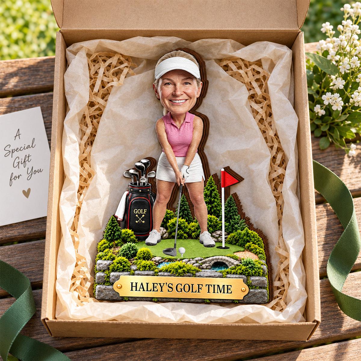 May include: A custom bobblehead figurine of a golfer wearing a pink polo shirt, white skirt, and white visor, standing on a miniature golf course base with a golf bag, flag, and stone bridge. A gold plaque reads HALEY'S GOLF TIME.