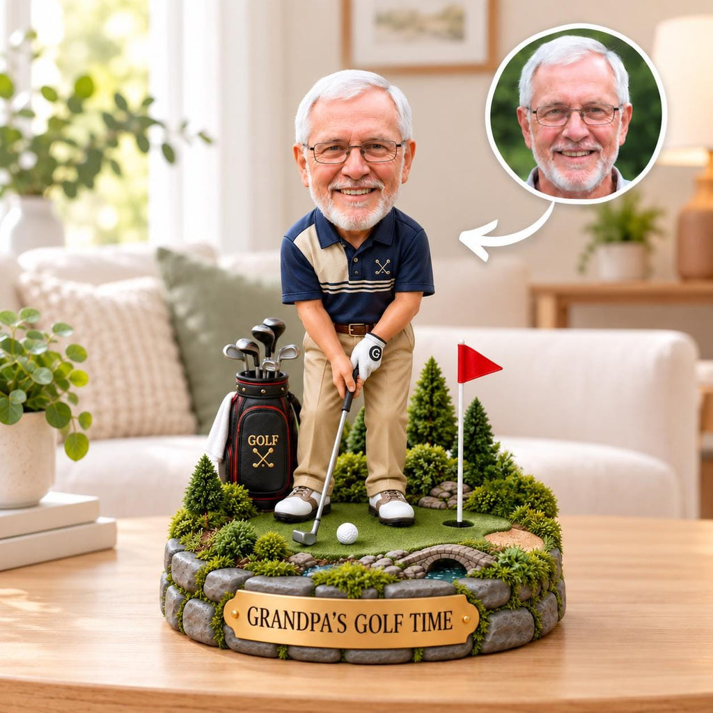 May include: A custom bobblehead figurine of an older man with glasses wearing a navy and beige polo shirt and khaki pants, standing on a golf course base with a golf bag, club, ball, flag, and a plaque that reads GRANDPA'S GOLF TIME.