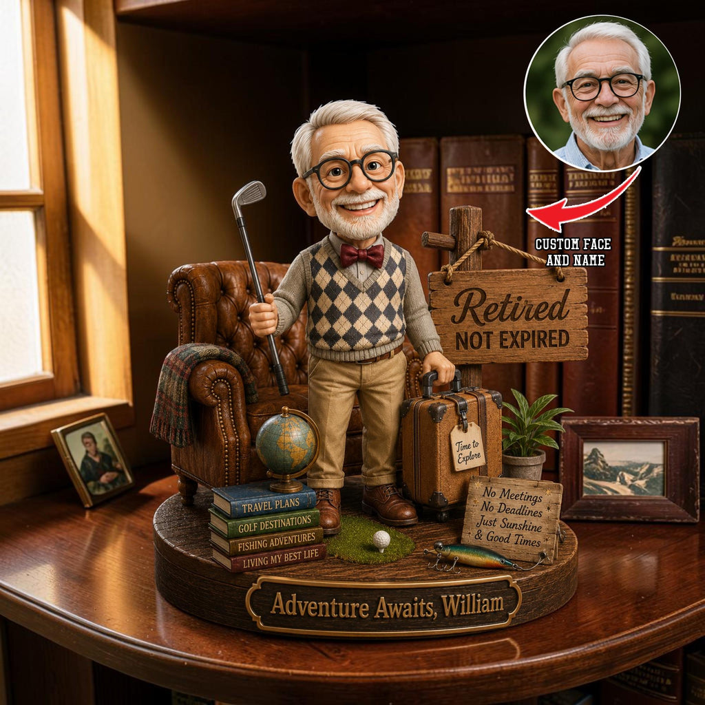 May include: A custom bobblehead figurine of an older man with glasses, a beard, and a sweater vest, holding a golf club. The base features a globe, books, a suitcase, and signs reading Retired Not Expired, Adventure Awaits, William, and Time to Explore.