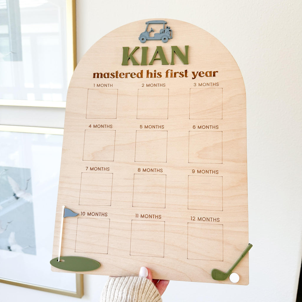 Hand holding personalized golf milestone board, demonstrating size and design details of wood and acrylic sign