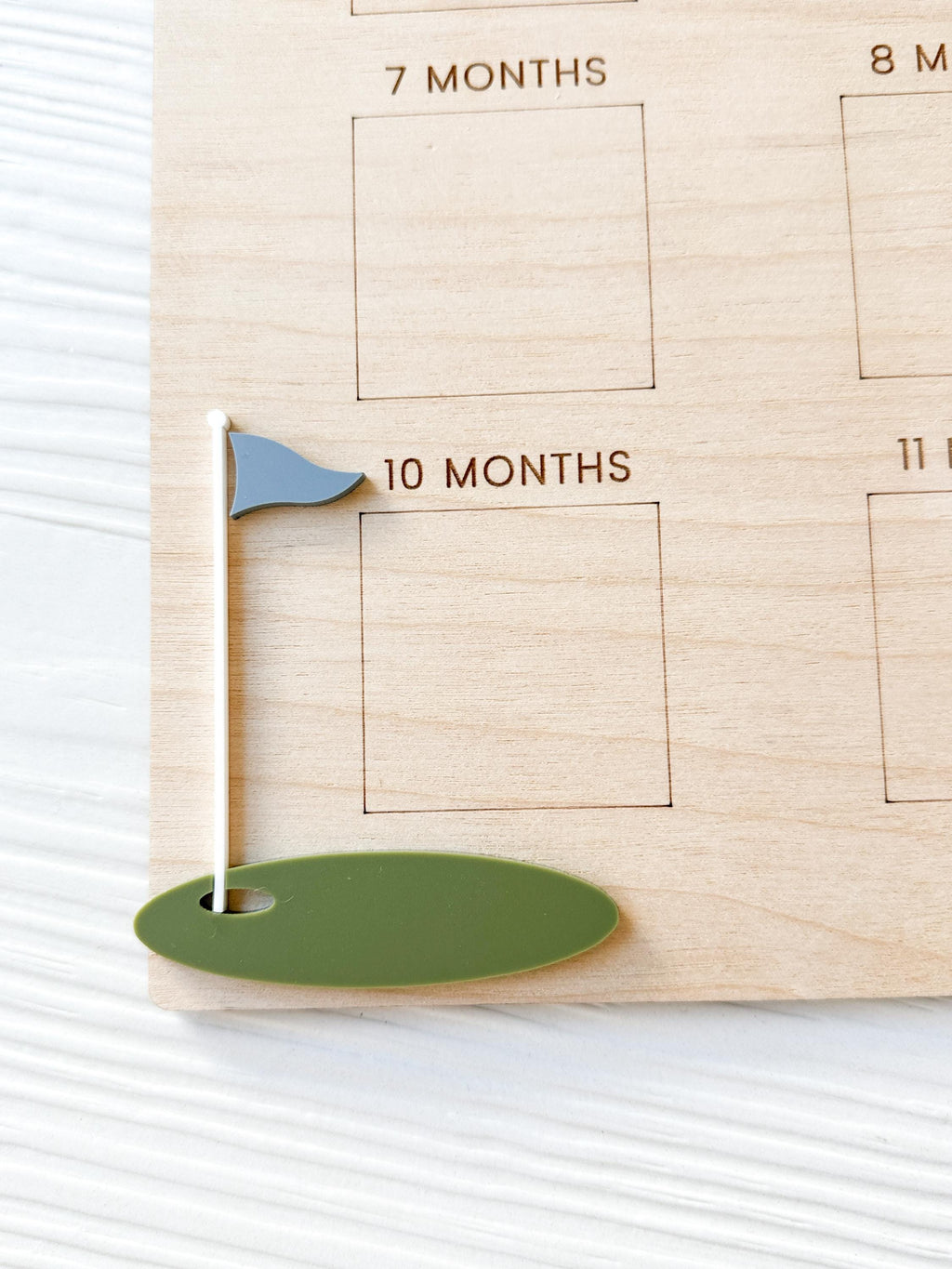Detail of wood grain and acrylic golf accents on golf birthday milestone board , showing high-quality craftsmanship and engraving